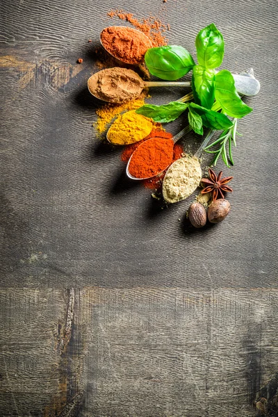 Tasty condiments on old board — Stock Photo, Image