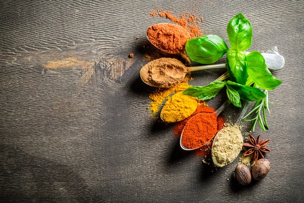 Intensive herbs and spices on old table — Stock Photo, Image