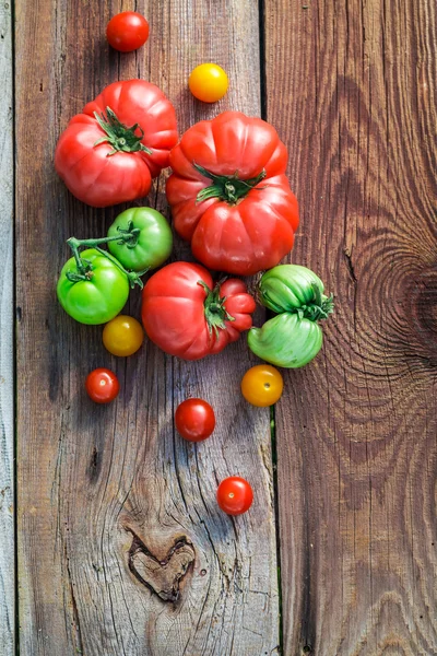 Healthy tomatoes on old wooden table — Stock Photo, Image