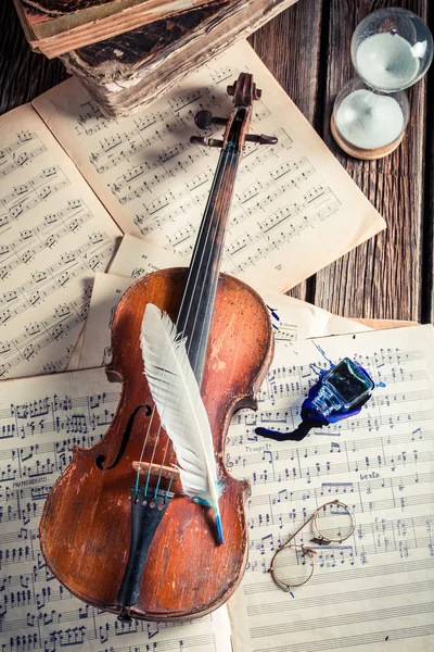 Vintage musical sheets and violin on old wooden table — Stok fotoğraf