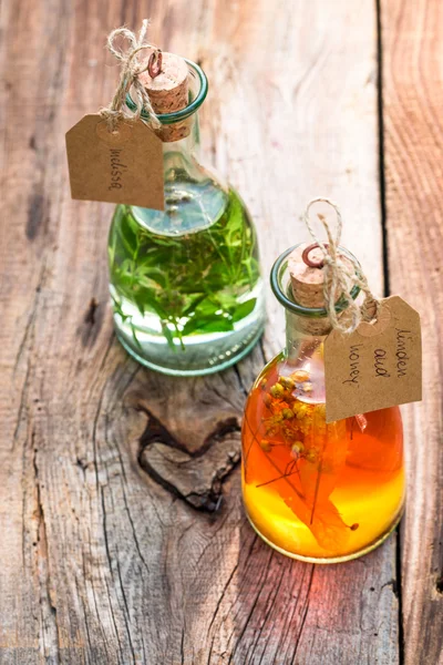 Healthy herbs in bottles with herbs and alcohol — Stock Photo, Image