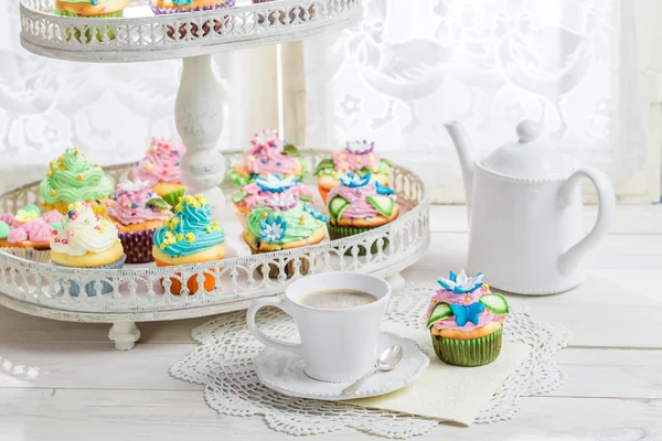 Tasty muffins with sweet decoration and coffee — Stock Photo, Image