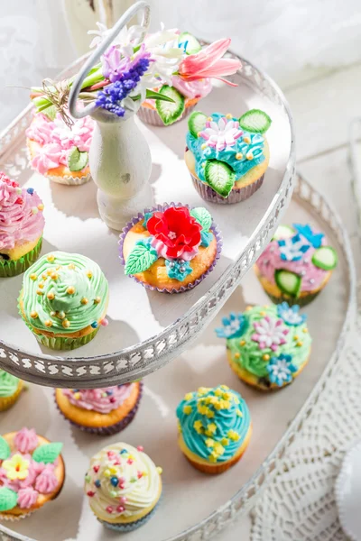 Sweet muffins with sweet decoration and cream — Stock Photo, Image