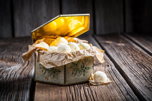 Coconut balls in old golden box — Stock Photo, Image