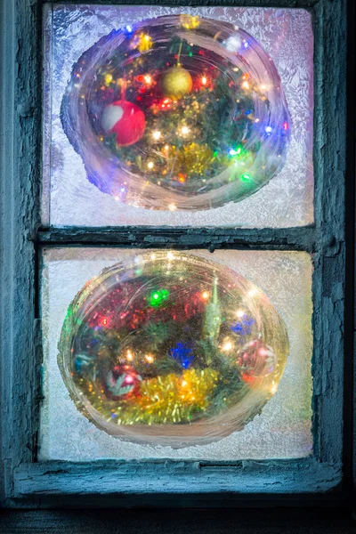 Вид на ялинку з замерзлого вікна вночі — стокове фото