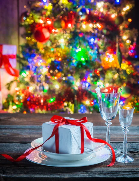 Beautiful gifts on plate at Christmas eve — Stock Photo, Image