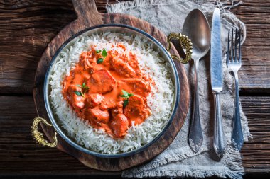Delicious tikka masala with rice and chicken in tomato sauce clipart
