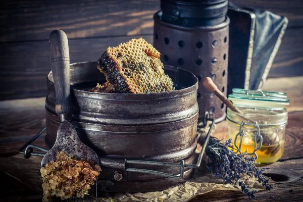 Antique beekeeper tools on old wooden table — Stock Photo, Image