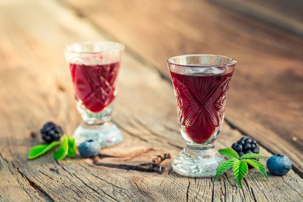 Healthy liquor with alcohol and berry fruits — Stock Photo, Image
