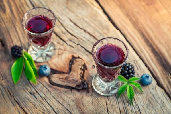 Homemade liqueur with alcohol and berry fruits — Stock Photo, Image