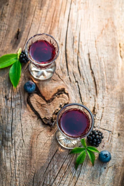 Homemade liquor with alcohol and berry fruits — Stock Photo, Image