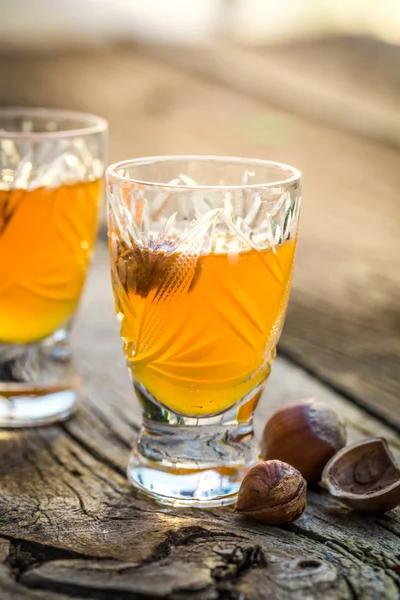 Delicious liqueur with hazelnuts and alcohol — Stock Photo, Image