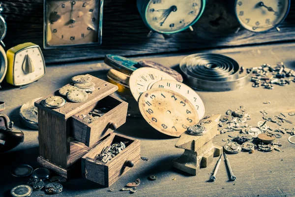 Aged watchmaker's room with parts of clocks — Stock Photo, Image