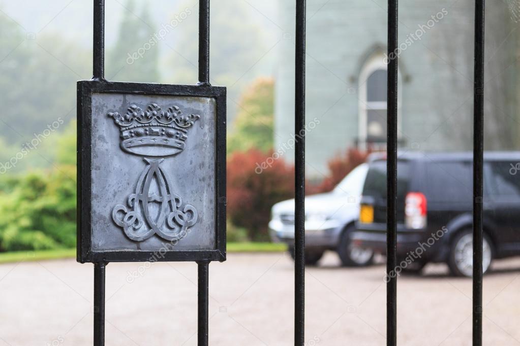 Fence of a gate to a luxury residence with crest