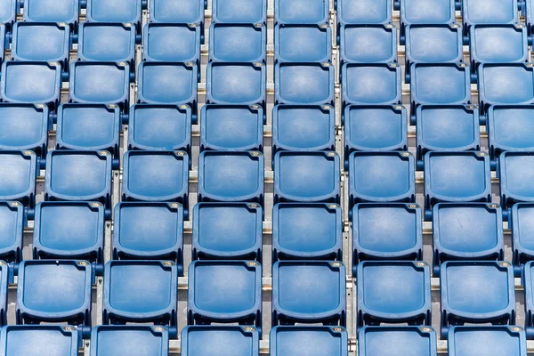 Stadium seating with blue folded up chairs — Stock Photo, Image