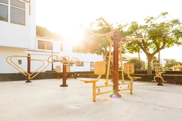 Public playground with outdoor fitness machines — Stock Photo, Image