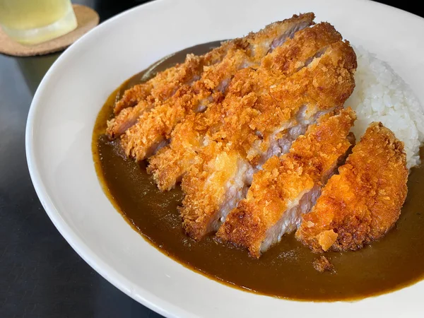 Closed up of Japanese curry rice with fried pork, serving on white plate, Japanese traditional food