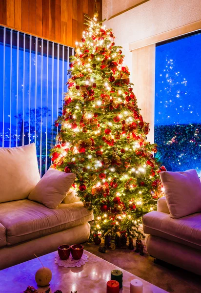 Christmas tree with golden lights in a cozy living room