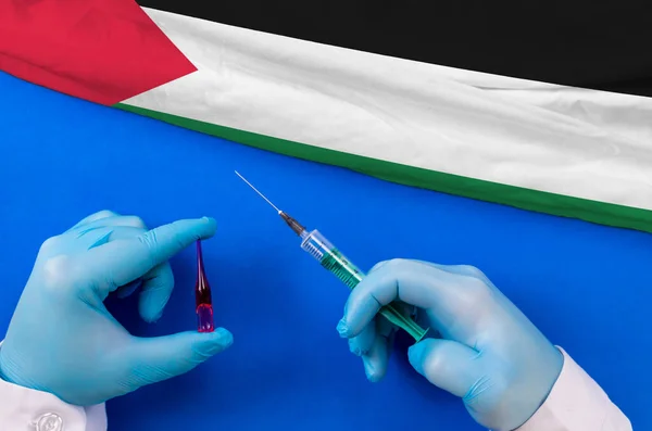 Western Sahara Vaccination. Hands of doctor holding syringe and coronavirus (COVID-19) vial vaccine on flag Western Sahara
