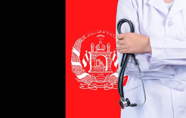 Female doctor with stethoscope in hand on the background of the Afghanistan flag. Concept medicine, pandemic in the country