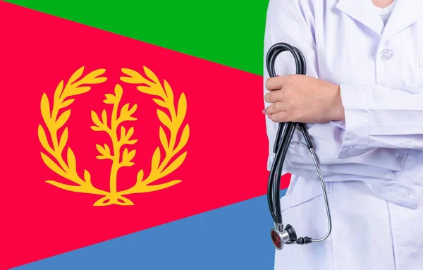 Female doctor with stethoscope in hand on the background of the Eritrea flag. Concept medicine, pandemic in the country