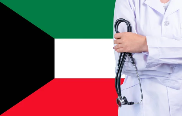 Female doctor with stethoscope in hand on the background of the Kuwait flag. Concept medicine, pandemic in the country