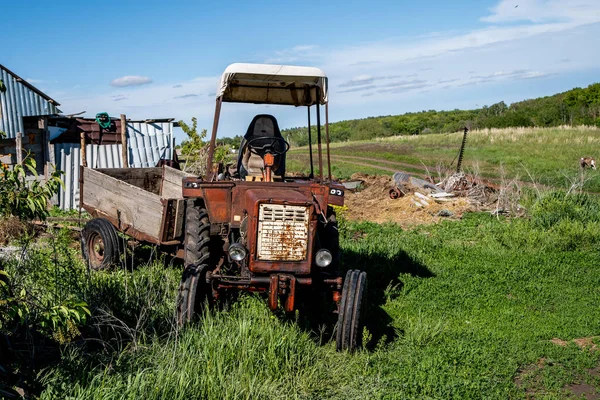 old tractor with a cart for transportation in the village