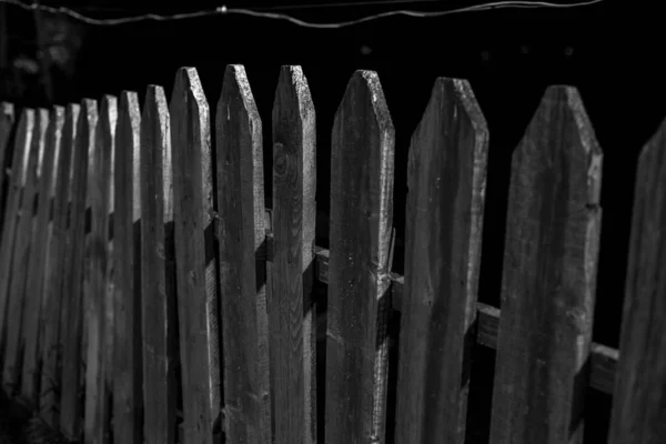 wooden fence at night in the light of the lantern. night photograph of wooden fence