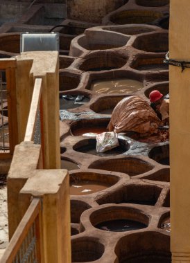 Fes el Bali 'deki ünlü Chouara Tabakhanesinde çalışan bir adamın resmi.).