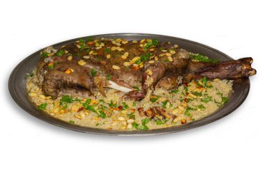 Arabic ouzi (stuffed lamb with rice). A kind of traditional Arabian food. decorated with almonds, nuts, and parsley. clipart