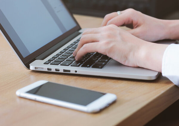 woman typing on laptop