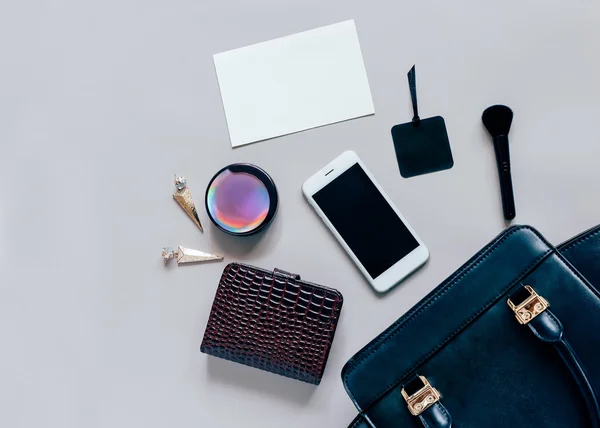 woman bag open out with cosmetics