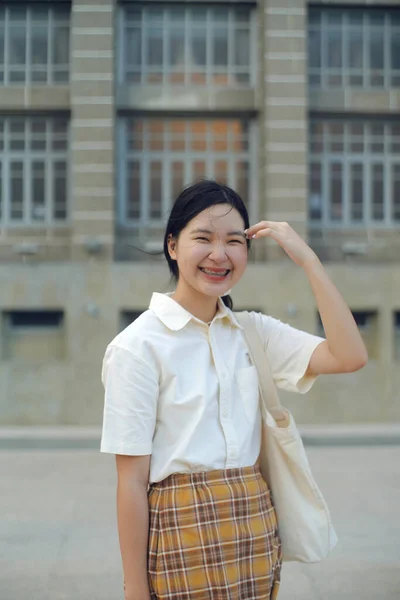 Young asian millennial teen girl smiling with braces in fashion style, happy feeling