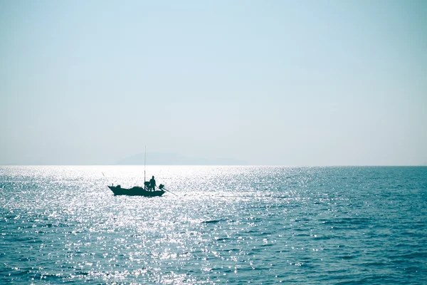 Fisherman in blue sea — Stock Photo, Image