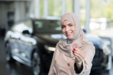 Kriptokürlük. Bitcoin ile araba değişimi. Yeni bir araba almak için Bitcoin 'i elinde tutan kadına yakın çekim.