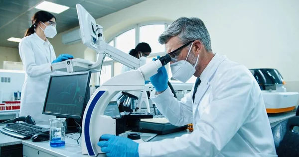 Side View Senior Caucasian Male Medical Researcher Working Lab Microscope — Zdjęcie stockowe