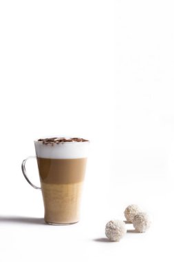 Latte macchiato in a tall glass on a white background . Cafe latte layered with milk in a high drinking glass. Minimalism. opy space clipart