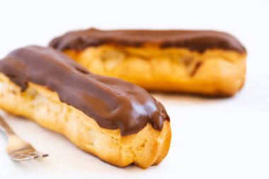 Geleneksel Fransız tatlısı. Beyaz arka planda iki ekler. Tatlı pasta ürünleri.