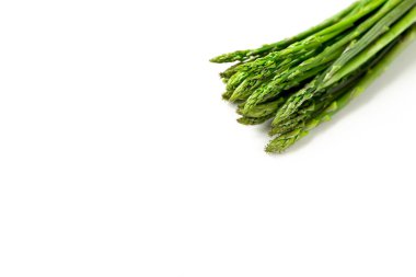 Beyaz arka planda bir demet taze kuşkonmaz.