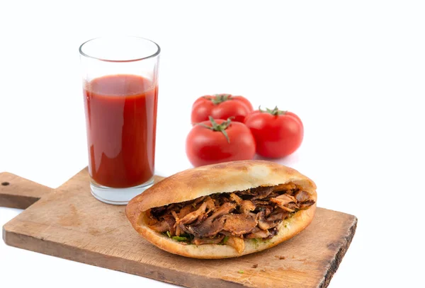 shawarma in pita bread ,tomatoes and tomato juice on a white background.doner kebab