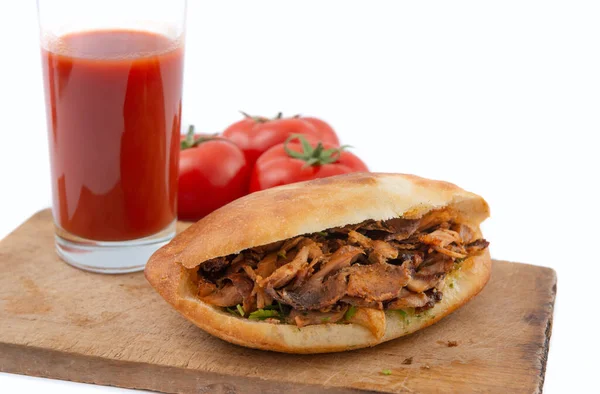 shawarma in pita bread ,tomatoes and tomato juice on a white background.doner kebab