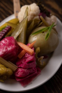 Tahta masadaki bir tabakta sebze turşusu..