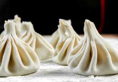 Aşçı ahşap masada khinkali yapıyor. İşlem hazırlığı Gürcistan yemeği. yiyecek konsepti.