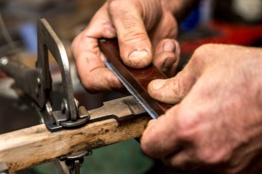 Avcı bıçağı yapan bir zanaatkârın yakın çekimi..