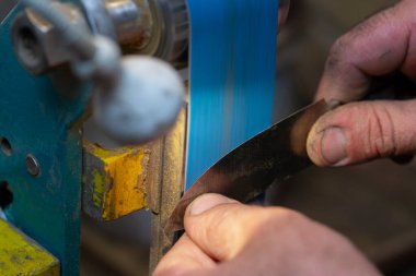 Avcı bıçağı yapan bir zanaatkârın yakın çekimi..