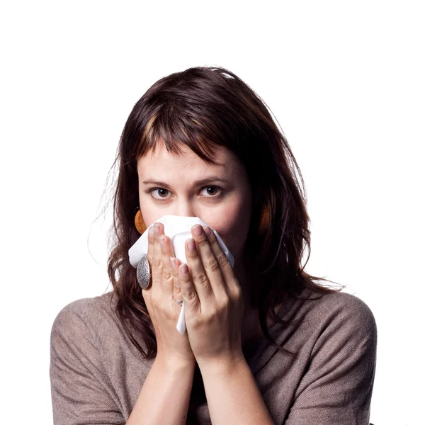 Woman with a cold sneezes — Stock Photo, Image