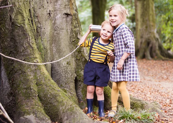 Children listening with a  tin can. — Stock Photo, Image