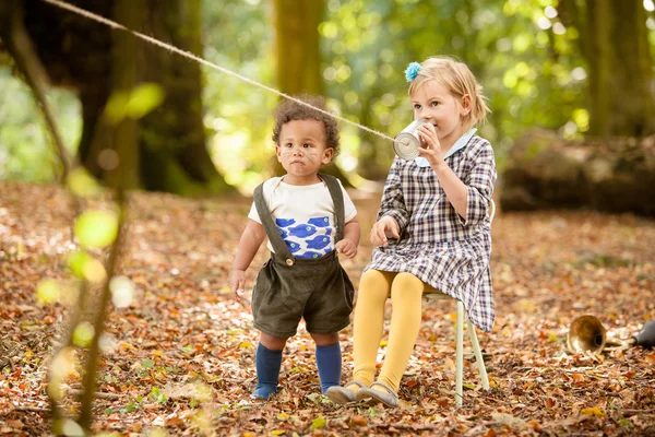 Children talking on a tin can — Stock Photo, Image