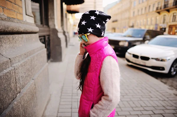 Niña feliz hablando en el teléfono inteligente en la ciudad — Foto de Stock