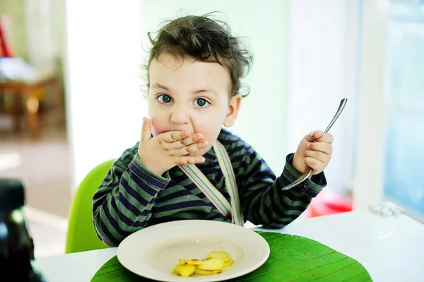 Baby eating food with a spoon, — Stock Photo, Image